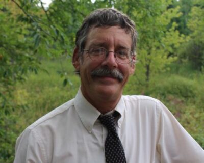 Brian Blair is pictured with trees in the background.