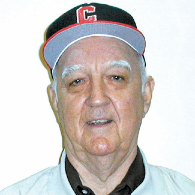 Don Coss is pictured in a Cincinnati Reds baseball hat.