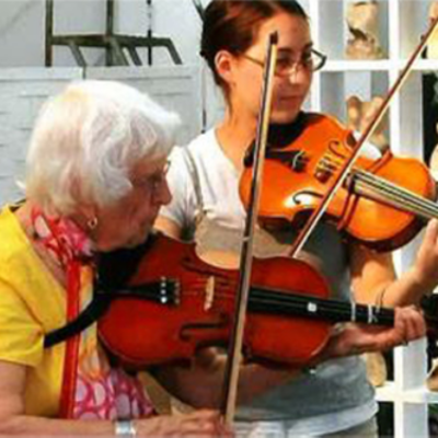 Helen Grettler is seen playing the violin with another woman.